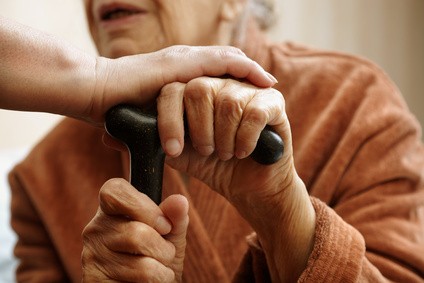 Elderly care home resident in a private room, representing the choice between council-funded and premium care home placements in the UK